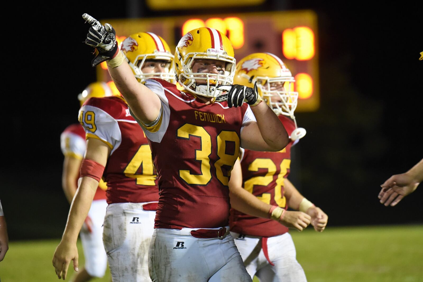 Fenwick’s John Stevenson (38) signals possession for the Falcons after a fumble recovery during Friday night’s 34-19 victory over Chaminade Julienne at Krusling Field in Middletown. CONTRIBUTED PHOTO BY ANGIE MOHRHAUS