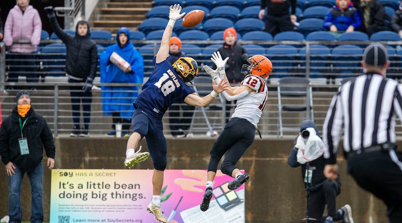 Versailles junior Jace Watren and Kirtland sophomore Will Beers fight for a pass during the Division VI state championship game against Kirtland on Friday morning at Tom Benson Hall of Fame Stadium in Canton. MIchael Cooper/CONTRIBUTED