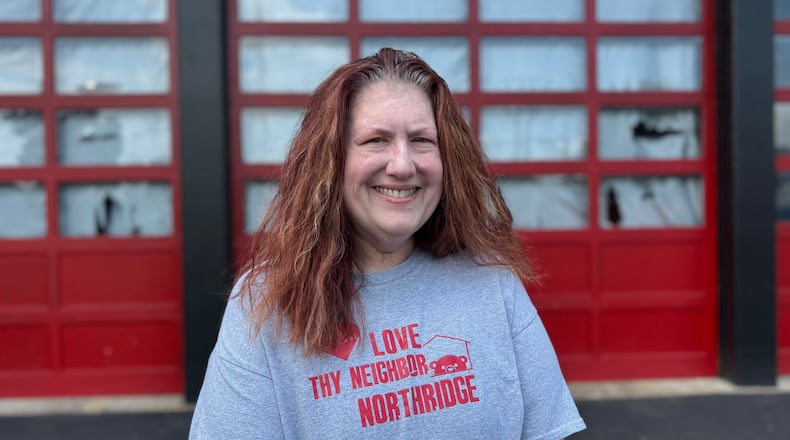 Nicole Lowe, co-founder of Polar Bear Book Swap in front of a Northridge fire station on July 14, 2025. Through a collaboration with Harrison Township, the nonprofit was given the space to use as a main headquarters to store, sort and organize books in. GRAETER / STAFF