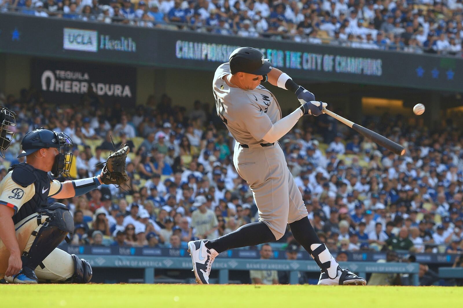 New York Yankees' Aaron Judge, right, hits a solo home run as Los Angeles Dodgers catcher Will Smith watches during the fourth inning of a baseball game Saturday, May 31, 2025, in Los Angeles. (AP Photo/Mark J. Terrill)
