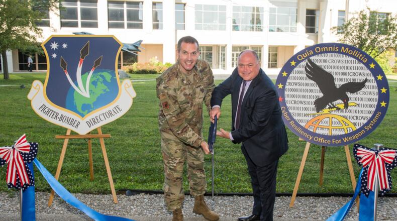 In a photo taken last month, Brig. Gen. Heath Collins and Joseph Bradley open a cyber defense facility at Wright-Patterson Air Force Base for the Air Force Life Cycle Management Center’s Fighters and Bombers Directorate. (U.S. Air Force photo by Wesley Farnsworth)