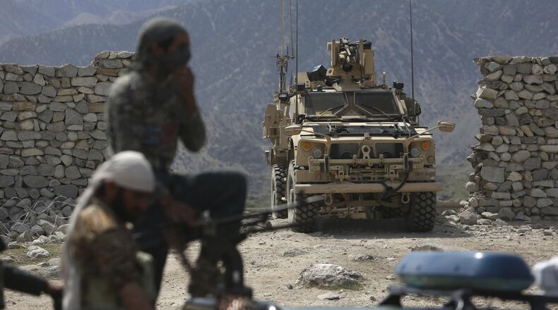 In this April 17, 2017 file photo, U.S. forces and Afghan security police are seen in Asad Khil near the site of a U.S. bombing in the Achin district of Jalalabad, east of Kabul, Afghanistan. Behind the detail-scarce rhetoric of the new Afghanistan strategy, elements of President Donald Trump’s broader approach to foreign conflicts emerge: secret military plans, no “nation-building” and a reliance on regional players to squeeze wayward nations and extremist groups. (AP Photo/Rahmat Gul, File)