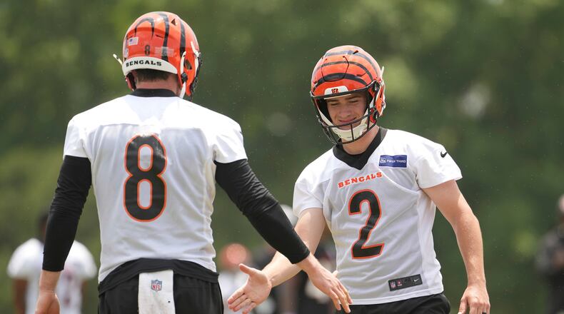 Cincinnati Bengals place kicker Evan McPherson (2) slaps hands with punter Ryan Rehkow (8) during NFL football practice Tuesday, June 3, 2025, in Cincinnati. (AP Photo/Kareem Elgazzar)