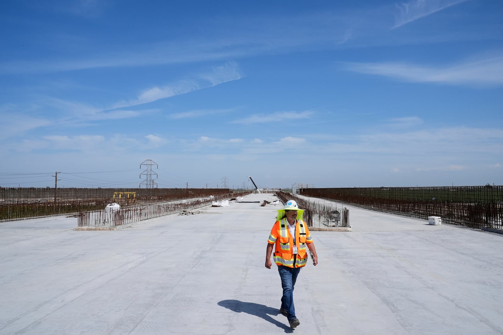 Eduardo Reyes, senior transportation engineer with the California High-Speed Rail Authority, walks through the Hanford Viaduct construction site, Tuesday, April 15, 2025, in Kings County, Calif. (AP Photo/Godofredo A. Vásquez)