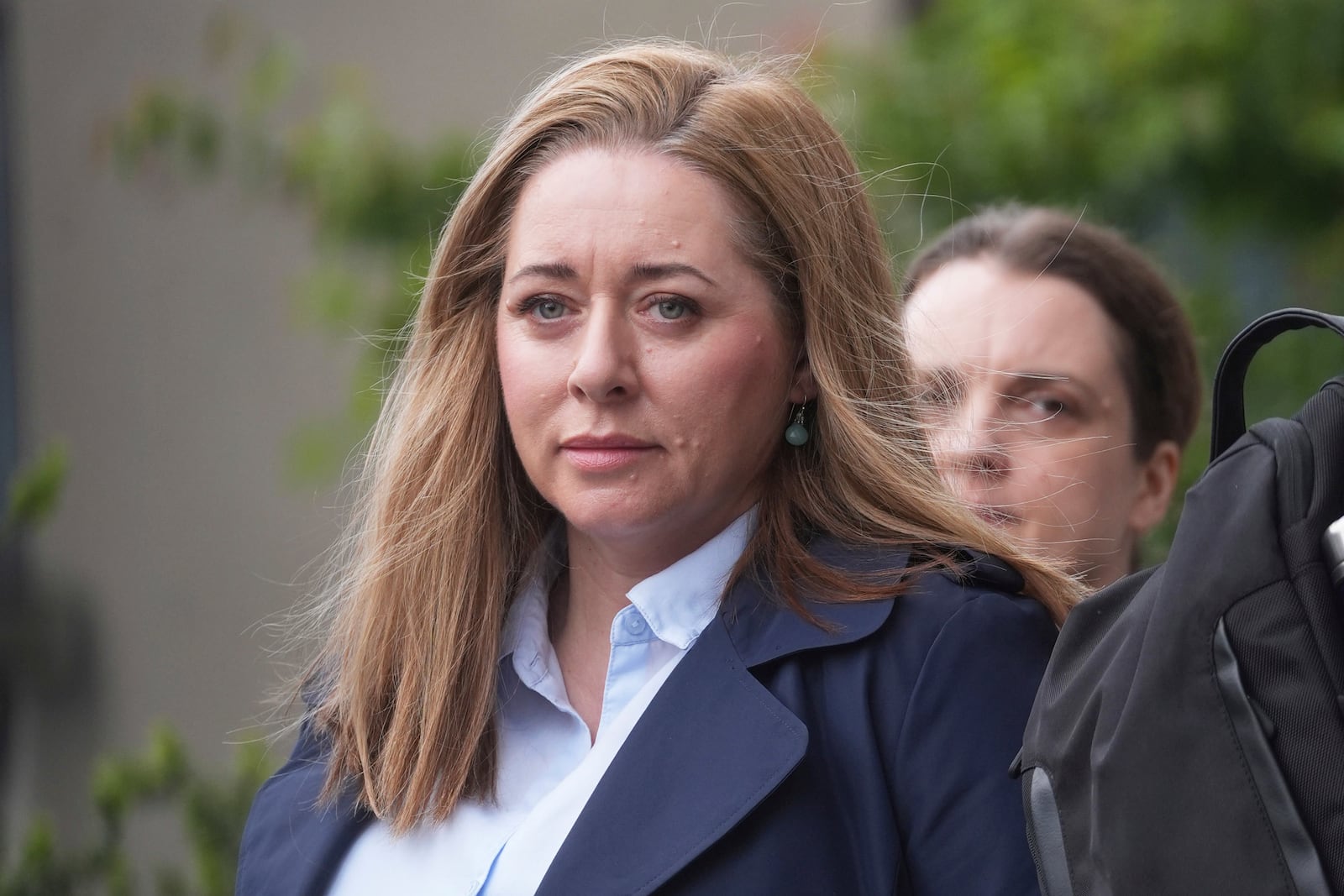 Journalist Jennifer O'Leary walks outside the High Court where where former Sinn Fein president Gerry Adams is bringing a legal action against the BBC over allegations about the murder of an MI5 spy in 2006, in Dublin, Ireland, Wednesday May 28, 2025. (Brian Lawless/PA via AP)