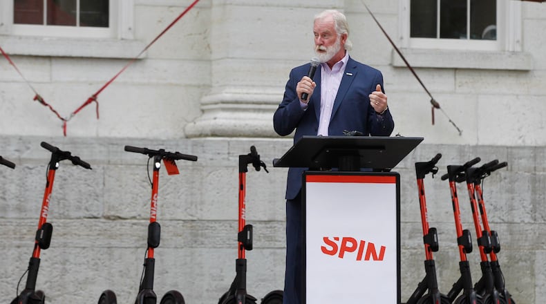 Greater Dayton RTA Chief Executive Officer Mark Donaghy with Spin Electric Scooters at Courthouse Square on Wednesday. RTA held a launch party to introduce the scooters to the city of Dayton. Donaghy along with residents and other civic leaders rode the scooters around two city blocks.   TY GREENLEES / STAFF