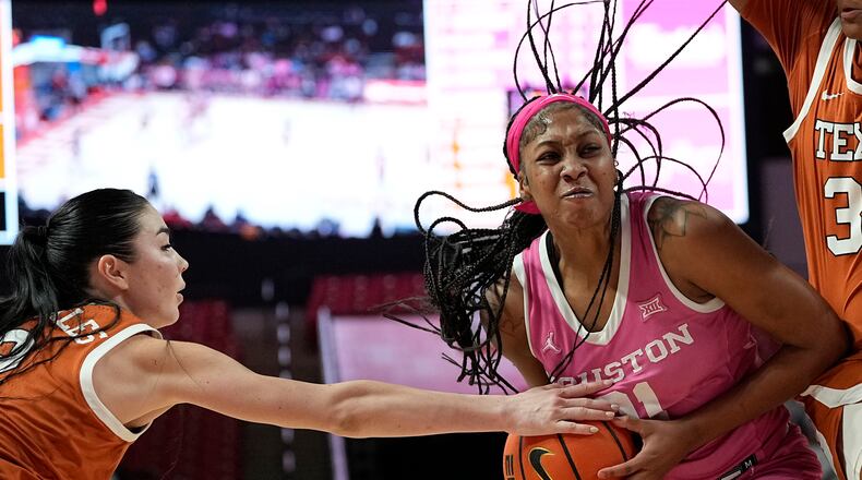 Houston forward Maliyah Johnson, right, has the ball knocked away by Texas guard Shaylee Gonzales, left, during the second half of an NCAA college basketball game, Wednesday, Feb. 14, 2024, in Houston. (AP Photo/Kevin M. Cox)