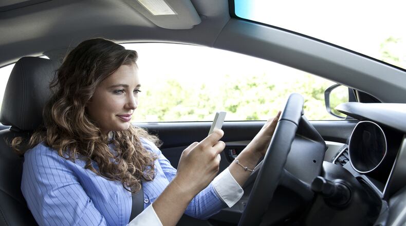 Distracted driving is both dangerous and common. (Dreamstime)