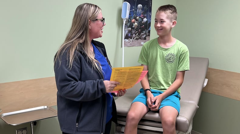 Wendy Owen, public health nurse supervisor, and Isaac Royer-Miller of Trotwood in the Dayton & Montgomery County Public Health Immunization Clinic located at 117 S Main St. in Dayton. CONTRIBUTED