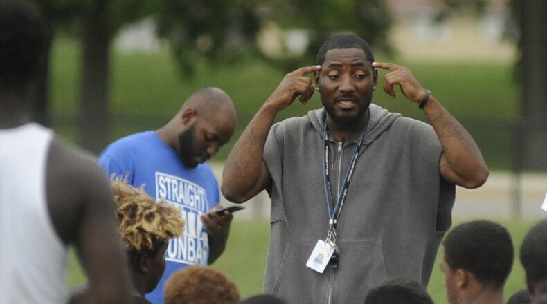 Dunbar head football coach Darran Powell addresses the Wolverines during practice Sept. 8, 2016. MARC PENDLETON / STAFF