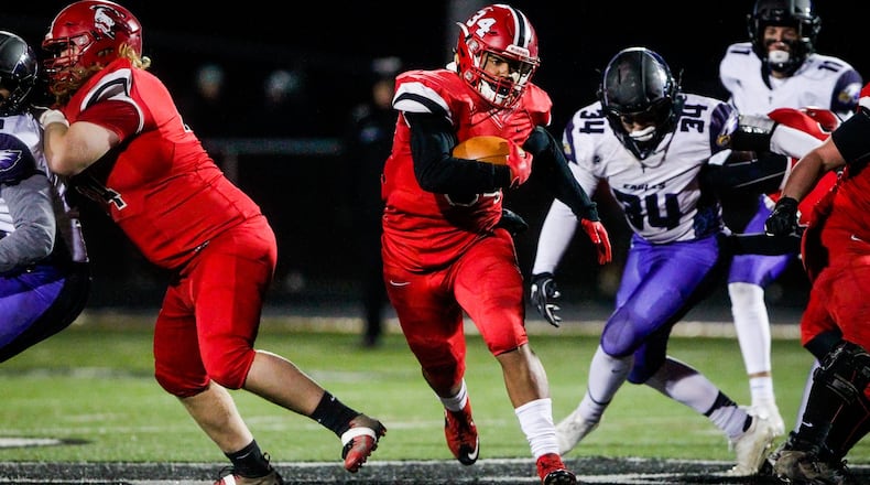 Madison’s Evan Crim breaks through a hole and heads up the field Saturday night during the Mohawks’ 50-6 triumph over Cincinnati Hills Christian Academy in a Division V, Region 20 playoff semifinal at Lakota East. NICK GRAHAM/STAFF