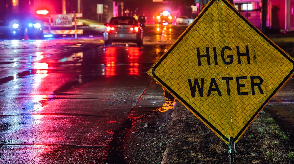 A crew from Ohio Department of Transportation works to clear drains on a flooded Germantown Road early Thursday morning, March 5, 2026 in Madison Township in Butler County. Heavy rain caused flooding in many areas. NICK GRAHAM/STAFF