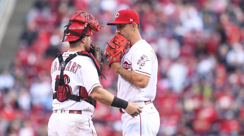 Reds catcher Tucker Barnhart talks to reliever Michael Lorenzen during a game against the Phillies on Monday, April 3, 2017, at Great American Ball Park in Cincinnati. David Jablonski/Staff