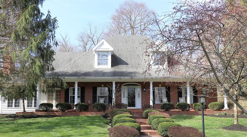 Listed for $824,900, the brick house in Beavercreek Twp. is on a 1.877-acre lot with mature trees, a stone-lined creek and an in-ground swimming pool. CONTRIBUTED PHOTOS/KATHY TYLER