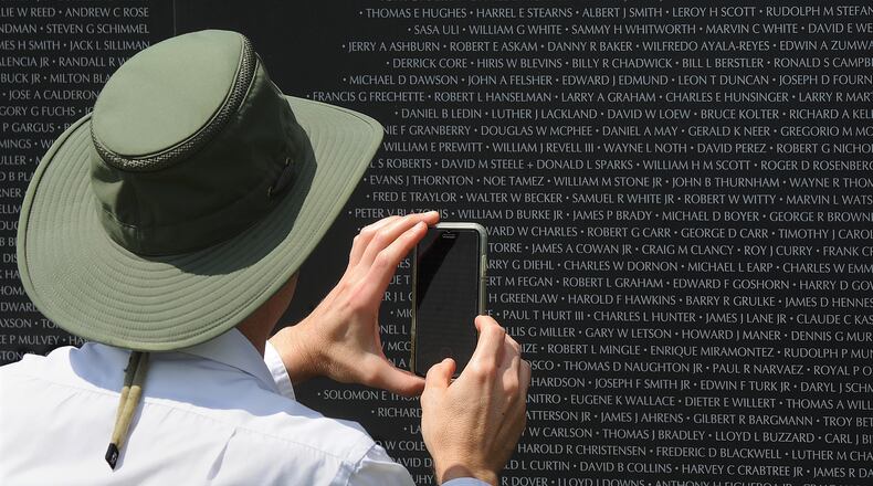 Thousands of people came to see the American Veterans Traveling Tribute Vietnam Memorial Friday, Aug. 19, 2022, at the National Museum of the United States Air Force. This 80% replica of the Vietnam Wall bears the names of more than 58,000 service members killed in Southeast Asia. MARSHALL GORBY / STAFF