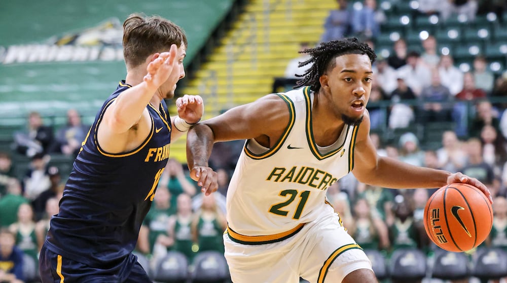 Wright State junior guard Logan Woods dribbles with pressure from Franklin College's David Streitmatter during a season opener on Monday, Nov. 3 at Ervin J. Nutter Center in Fairborn. BRYANT BILLING/STAFF