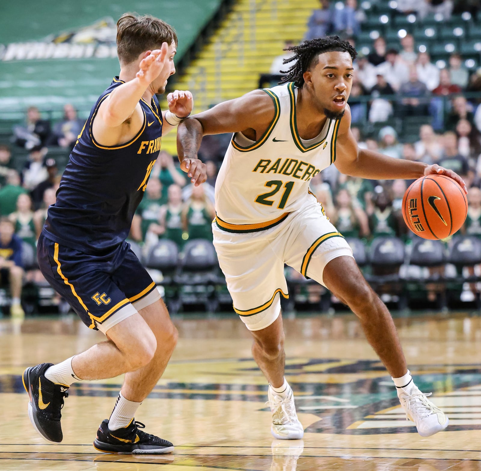 Wright State junior guard Logan Woods dribbles with pressure from Franklin College's David Streitmatter during a season opener on Monday, Nov. 3 at Ervin J. Nutter Center in Fairborn. BRYANT BILLING/STAFF
