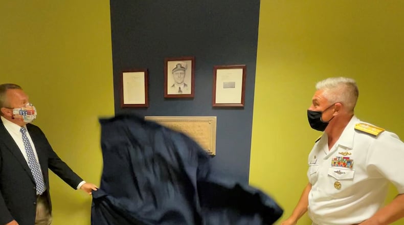 Retired Brig. Gen. Scott Wuesthoff (left) and Rear Adm. John Spencer, Submarine Group 10 commander, unveil a plaque honoring the service and sacrifice of U.S. Navy Cmdr. Eric Liljencrantz on July 26 at Wright-Patterson Air Force Base. The ceremony was held in conjunction with the Navy's "Navy Week Dayton" event, which featured Fairborn, Ohio, native Spencer as lead officer and Wuesthoff attended as Liljencrantz' grandson. NAVAL MEDICAL RESEARCH UNIT-DAYTON PHOTO/OLIVIA TITER