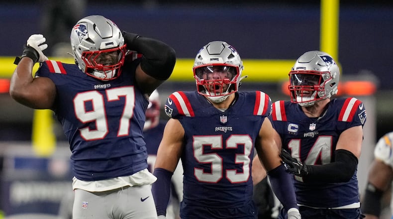 New England Patriots defensive end Milton Williams (97), linebacker Christian Elliss (53) and linebacker Robert Spillane (14) celebrate Williams' sack of Los Angeles Chargers quarterback Justin Herbert (10) in the second half of an NFL wild-card playoff football game in Foxborough, Mass., Sunday, Jan. 11, 2026. (AP Photo/Charles Krupa)