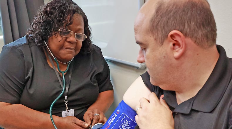File - Paden Frank gets his blood pressure taken by Bernadette Kidd at the Clark County Combined Health District Monday, June 26, 2023. Blood pressure, along with topics of cholesterol and strep throat, were among some of the top trending health-related questions last year. BILL LACKEY/STAFF