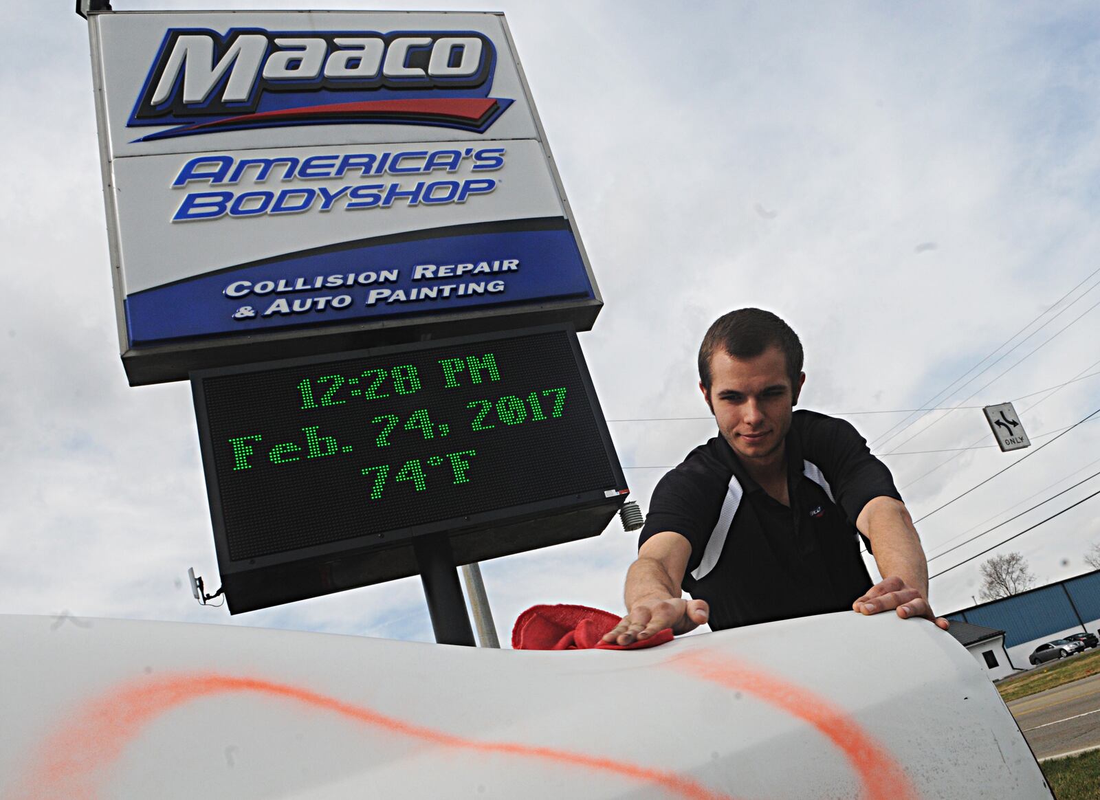 Joe Price, manager of the Maaco Bodyshop on Needmore Road was working outside on a unseasonably warm February day Friday. Temperatures soared to 76 degrees setting a record high for February. Staff photo/Marshall Gorby