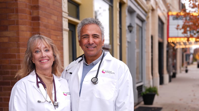 Pediatricians Dr. Jeff Manser, right, and Dr. Tina Gabbard, left, pictured Wednesday, Nov. 6, 2024, in downtown Wilmington, Ohio. Gabbard and Manser, who have been married for 37 years, will see patients at Cincinnati Children’s Wilmington Primary Care after it opens at 1150 W. Locust St. in January 2025. COURTESY OF CINCINNATI CHILDREN'S