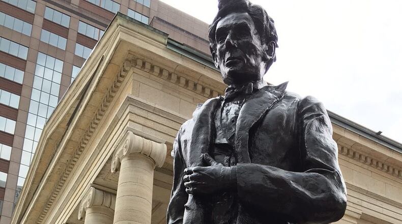 Sculptor Michael Major of Urbana created this bronze sculpture of President Abraham Lincoln as he looked in 1859 when he spoke on the steps of Montgomery County’s Old Court House. The sculpture was unveiled Saturday at Courthouse Square in front of the historic courthouse downtown Dayton. LYNN HULSEY / STAFF