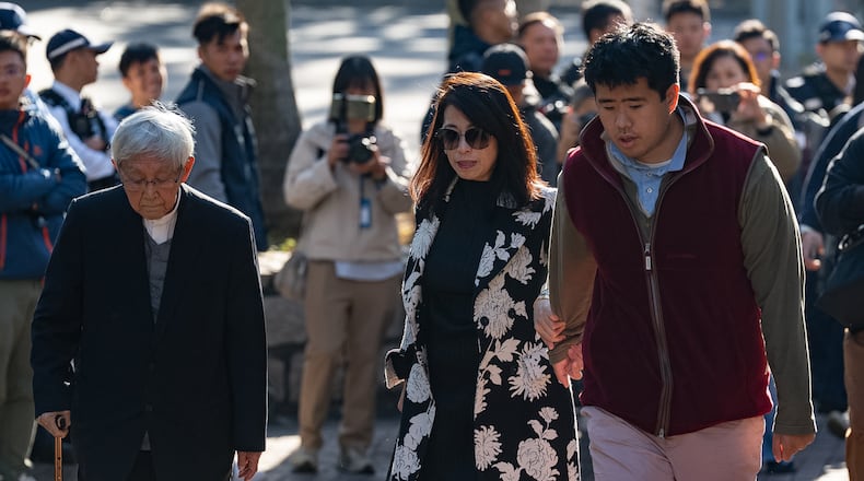Retired Chinese cardinal Joseph Zen Ze-Kiun, from left, Jimmy Lai's wife Teresa Lai and Jimmy Lai's son Augustin Lai arrive at the West Kowloon Magistrates' Courts ahead of the verdict for Hong Kong activist publisher Jimmy Lai's national security trial in Hong Kong, Monday, Dec. 15, 2025. (AP Photo/Chan Long Hei)