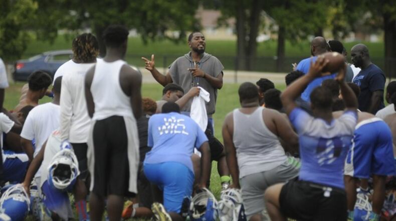 Head coach Darran Powell address the Dunbar High School football team at practice last season. MARC PENDLETON / STAFF