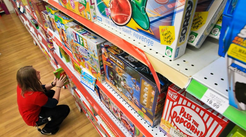 Beavercreek Toys “R” Us sales associate Devin Algren stocked the game shelves in preparation of the holiday shopping season in 2012. Staff photo by Jim Witmer