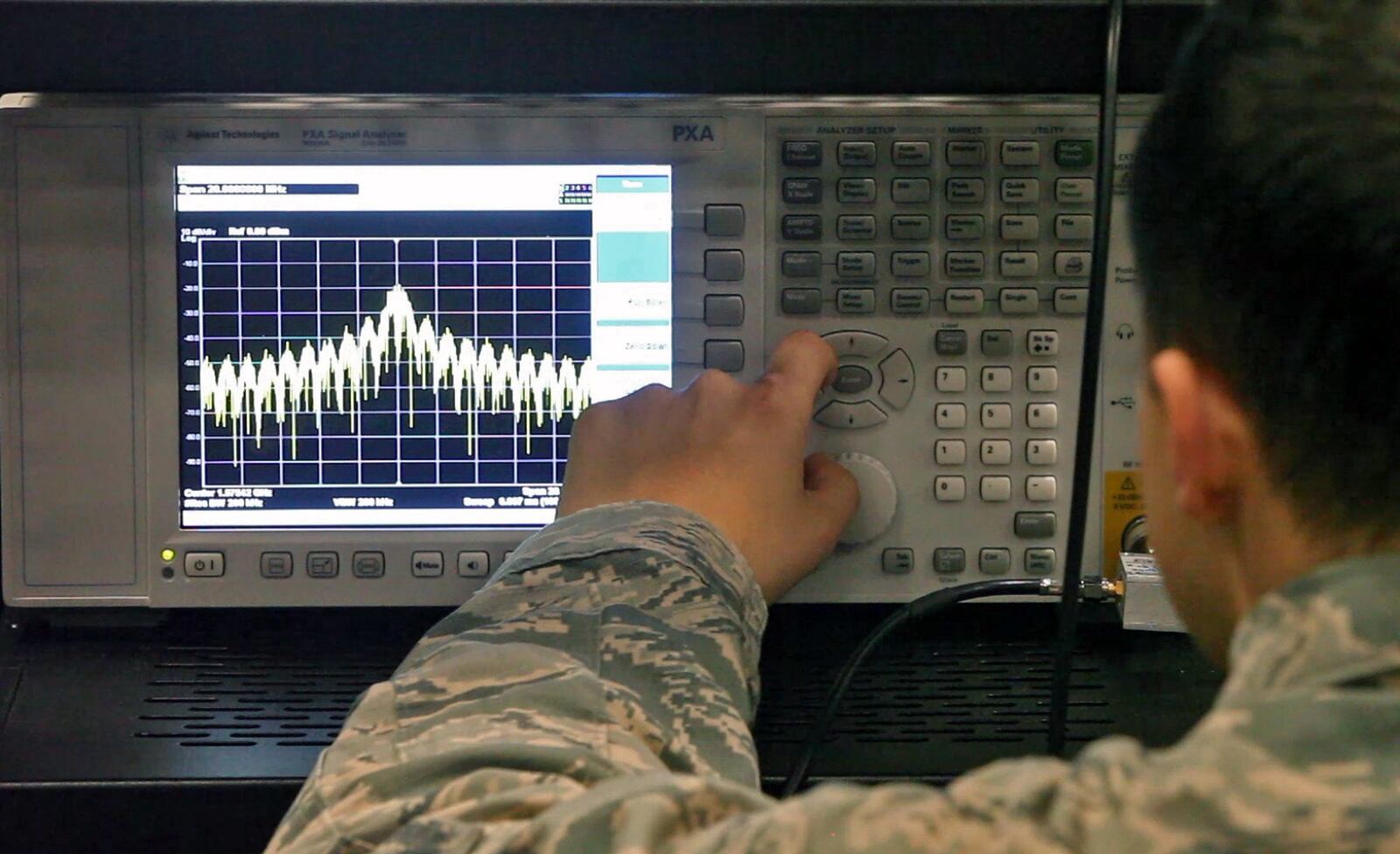 Graduate students analyze signals as they research the vulnerabilities of Bluetooth networks and devices at the Air Force Institute of Technology Center for Cyber Research at Wright-Patterson Air Force Base. TY GREENLEES / STAFF