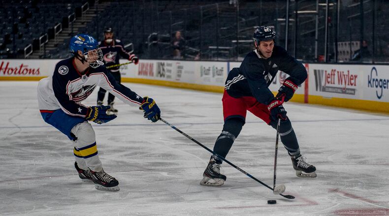 Sam Medvec (left) plays defense against former Columbus Blue Jackets winger Chris Clark during the Military Appreciation Night alumni game April 7 at Nationwide Arena in Columbus. U.S. AIR FORCE PHOTO/SENIOR AIRMAN JACK GARDNER