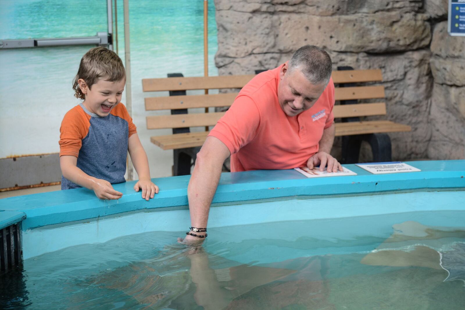 Newport Aquarium Executive Director Eric Rose loves Stringray Hideaway. Here, he interacts with a delighted young guest. CONTRIBUTED