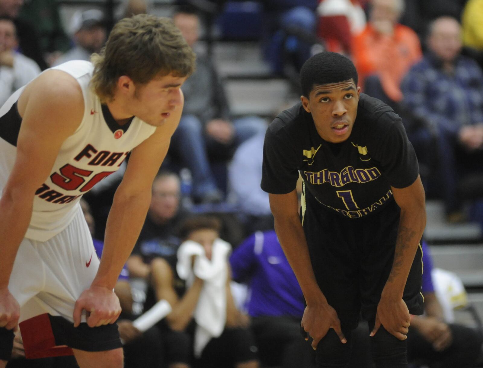 Fort Loramie’s Tyler Siegel and Eric Boykin Jr. of Thurgood. Fort Loramie defeated Thurgood Marshall 58-53 inthe 16th annual Premier Health Flyin’ to the Hoop at Trent Arena in Kettering on Mon., Jan. 15, 2018. MARC PENDLETON / STAFF