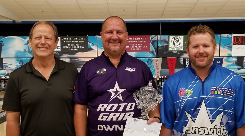 Kettering’s Brian Kretzer (center) won his first PBA50 Tour title last week at Spectrum Lanes in Michigan. Kretzer is pictured with Mike Eaton (left) and Mike Eaton, Jr. of Spectrum Lanes. CONTRIBUTED