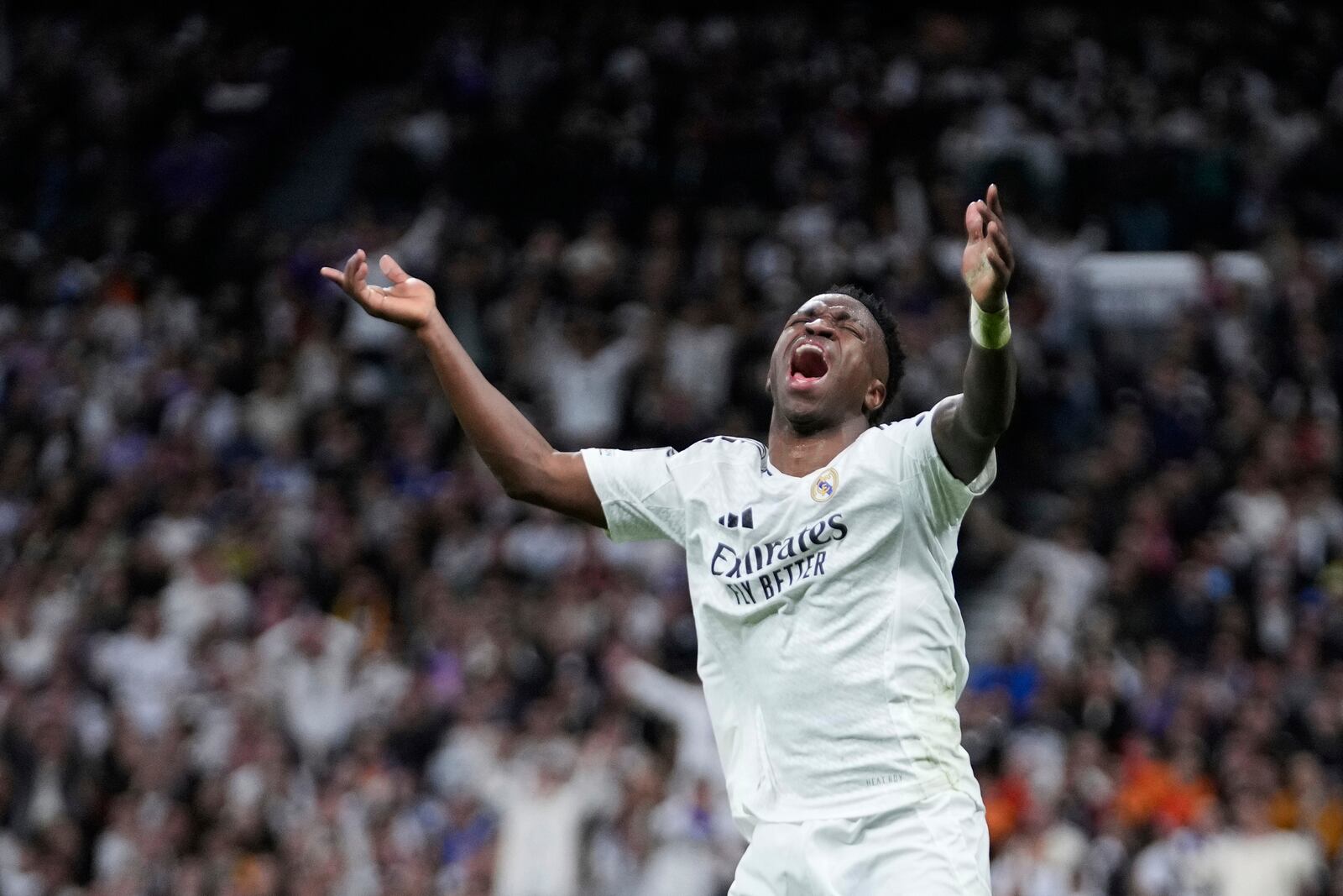 Real Madrid's Vinicius Junior reacts during the Champions League quarterfinals second leg soccer match between Real Madrid and Arsenal at the Santiago Bernabeu stadium in Madrid, Wednesday, April 16, 2025. (AP Photo/Bernat Armangue)