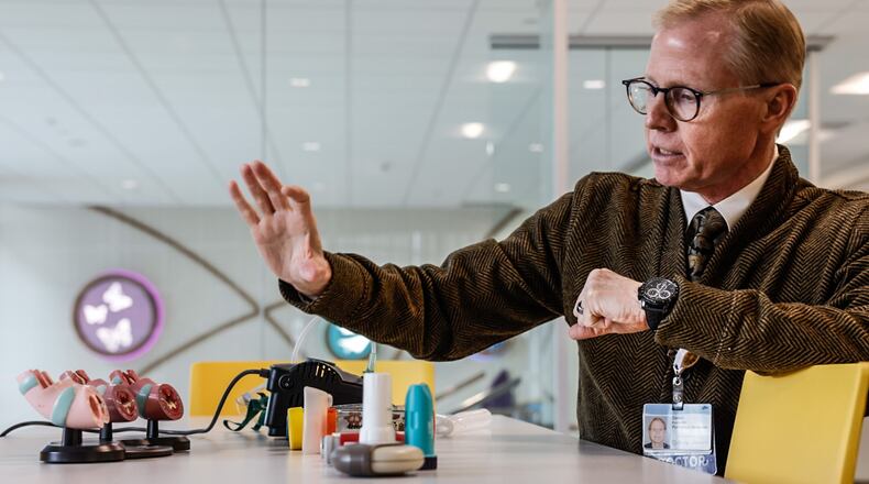 Dr. Daniel Evans, chief of the division of pulmonary medicine for Dayton Children's Hospital, explains the different types of inhalers children can use for asthma. Spacers can be used with inhalers to help people get more of the medication into their lungs instead of going into their stomachs, which doctors say can happen when inhalers aren't used with spacers. JIM NOELKER/STAFF
