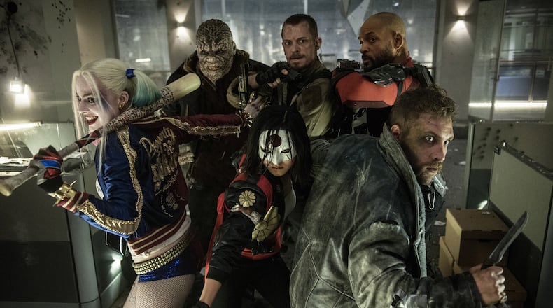 This image released by Warner Bros. Entertainment shows, from left, Margot Robbie, Adewale Akinnuoye-Agbaje, Karen Fukuhara, foreground center, Joel Kinnaman, Will Smith and Jao Courtney, foreground right, in a scene from “Suicide Squad,” opening nationwide on Aug. 5. (Clay Enos/Warner Bros. Entertainment via AP)