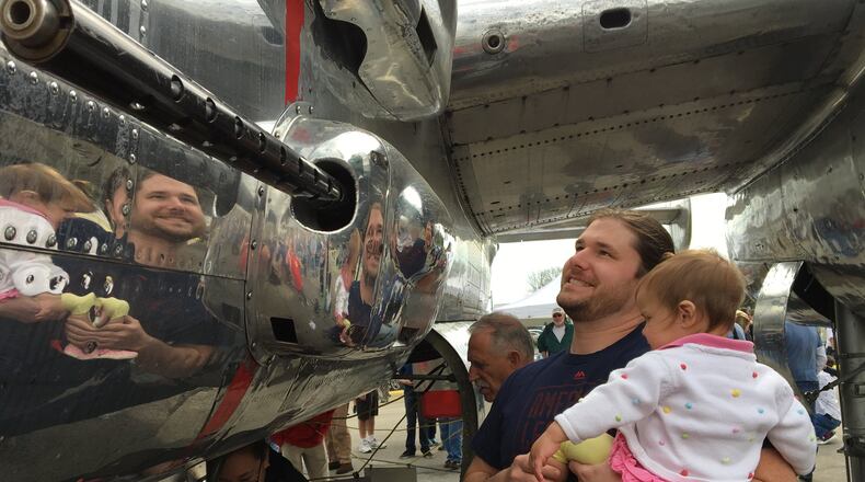 Brad Chandler looks over a B-25 aircraft with 18-month-old daughter Emery during Saturday’s 75th anniversary celebration of the 1942 Doolittle Raid over Tokyo at Grimes Field. BRETT TURNER / CONTRIBUTED