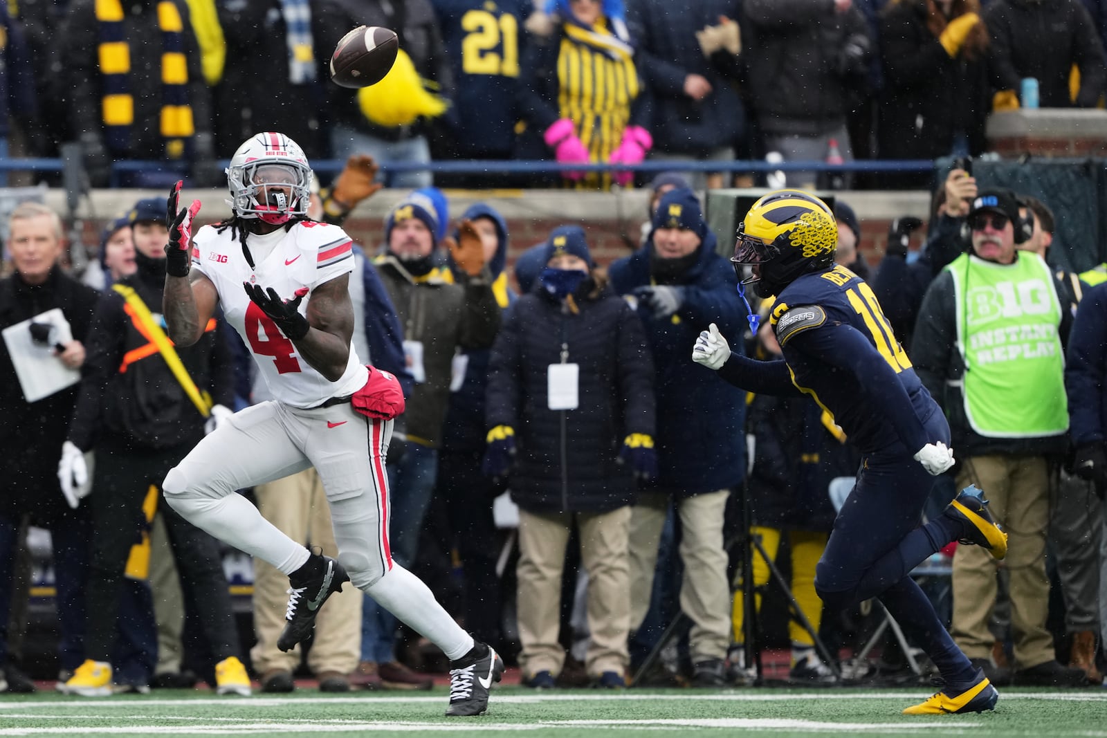 Ohio State wide receiver Jeremiah Smith, left, catches a pass for a touchdown against Michigan defensive back Zeke Berry during the first half of an NCAA college football game, Saturday, Nov. 29, 2025, in Ann Arbor, Mich. (AP Photo/Ryan Sun)