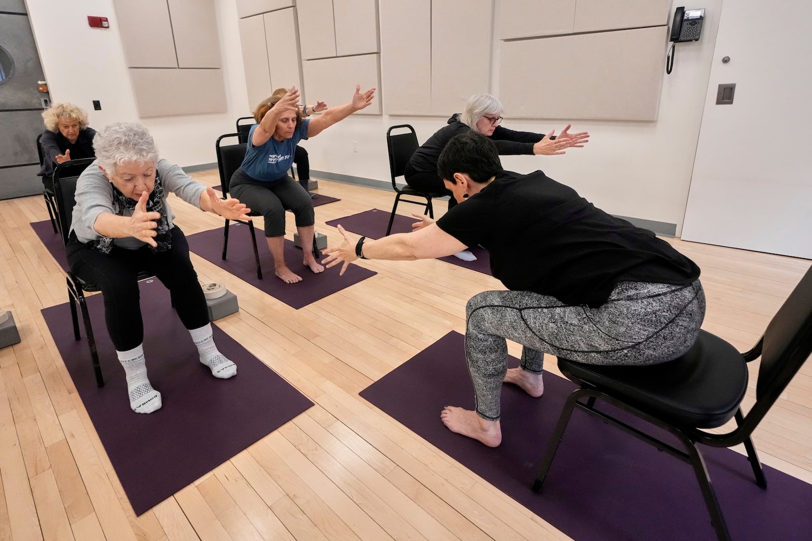 Whitney Chapman, right, conducts a chair yoga class at the Marlene Meyerson JCC Manhattan, in New York, March 28, 2025. (AP Photo/Richard Drew)