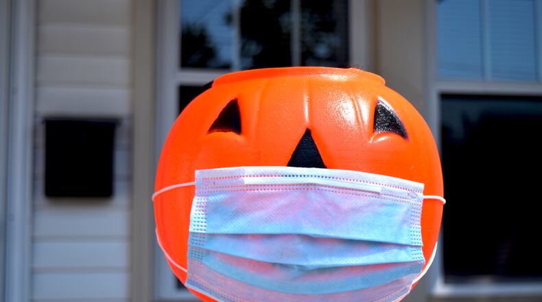 Health officials recommend people avoid door-to-door trick-or-treating or even "trunk-or-treating," by which children collect treats walking from car to car at gatherings in school or church parking lots. DAVID CARPIO / SHUTTERSTOCK