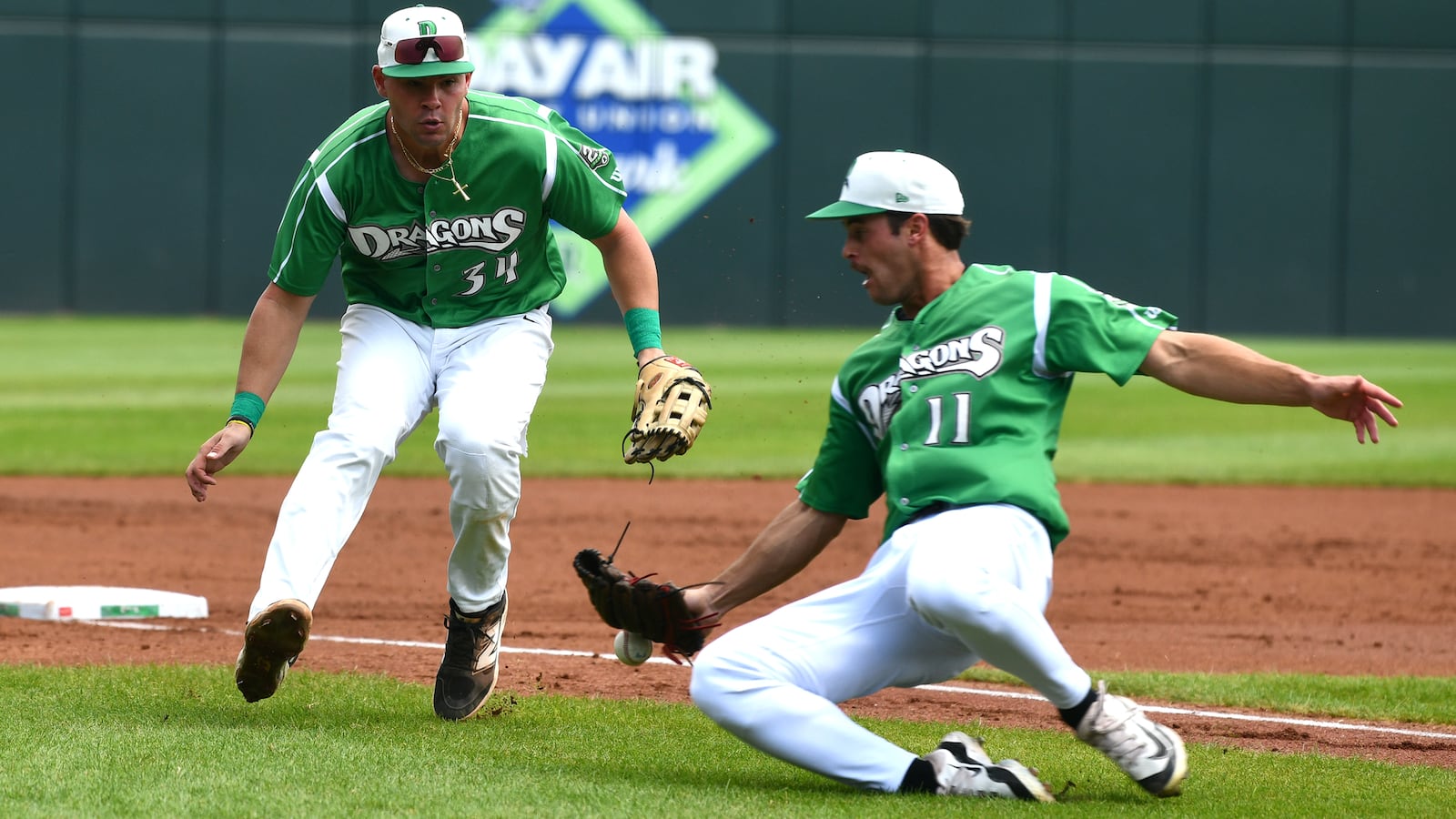 Dragons pitcher Nick Sando slides to try catch a popup in front of charging third baseman Carter Graham. JEFF GILBERT/CONTRIBUTED