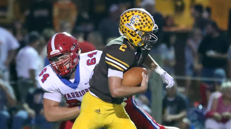 Northwestern’s Korbin Spencer sacks Kenton Ridge quarterback Dylan Lemen. Both were named All-Ohio Division IV first team. BILL LACKEY/STAFF