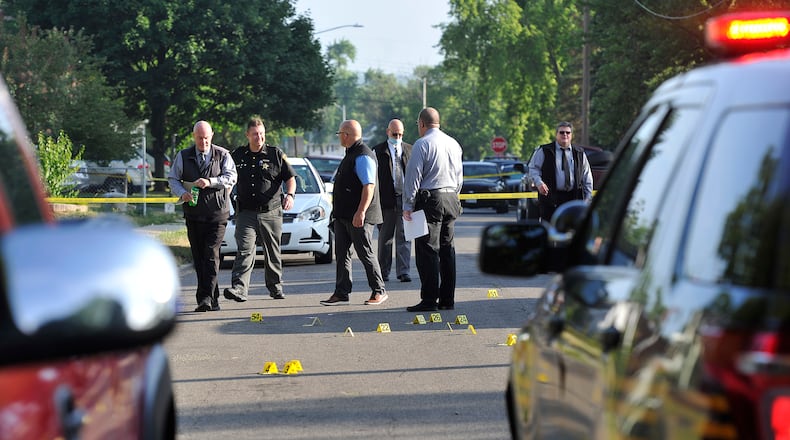Members of the Montgomery County Sheriff's Department investigate a shooting Friday on Fer Don Road in Harrison Township. MARSHALL GORBY\STAFF