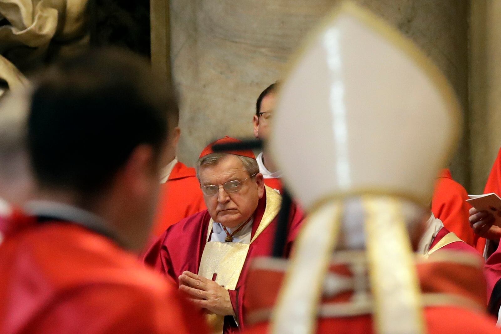 FILE - Cardinal Raymond Burke, center, looks at Pope Francis, right with back to camera, arriving for the funeral for late Cardinal William Joseph Levada, inside St. Peter's Basilica, at the Vatican, Sept. 27, 2019. (AP Photo/Alessandra Tarantino, File)