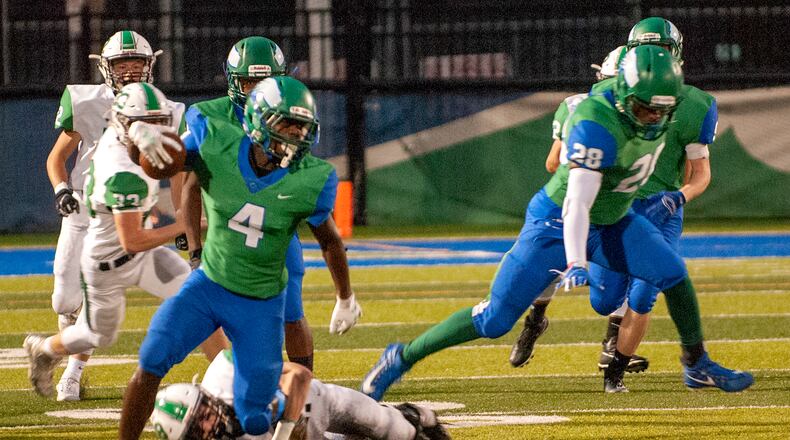 Chaminade Julienne receiver Kenyon Owens breaks a tackle during the first half of Friday night’s game against Hamilton Badin at CJ. Jeff Gilbert/CONTRIBUTED