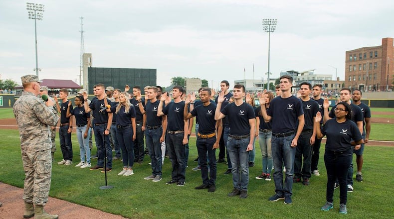 Lt. Gen. Robert McMurry, Air Force Life Cycle Management Center commander, administers the oath of enlistment to 31 members of the delayed enlistment program during the Hometown Heroes military appreciation night at Fifth Third Field Aug 18. (U.S. Air Force photo/Wesley Farnsworth)