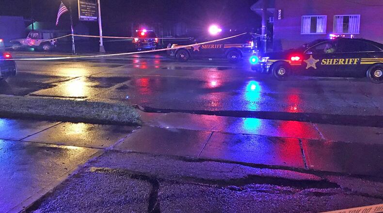 The Clark County Sheriff’s Office investigates the scene along Main Street in New Carlisle where Andy Grimm, the photographer for the New Carlisle newspaper, was shot by a deputy in September of 2017. STAFF