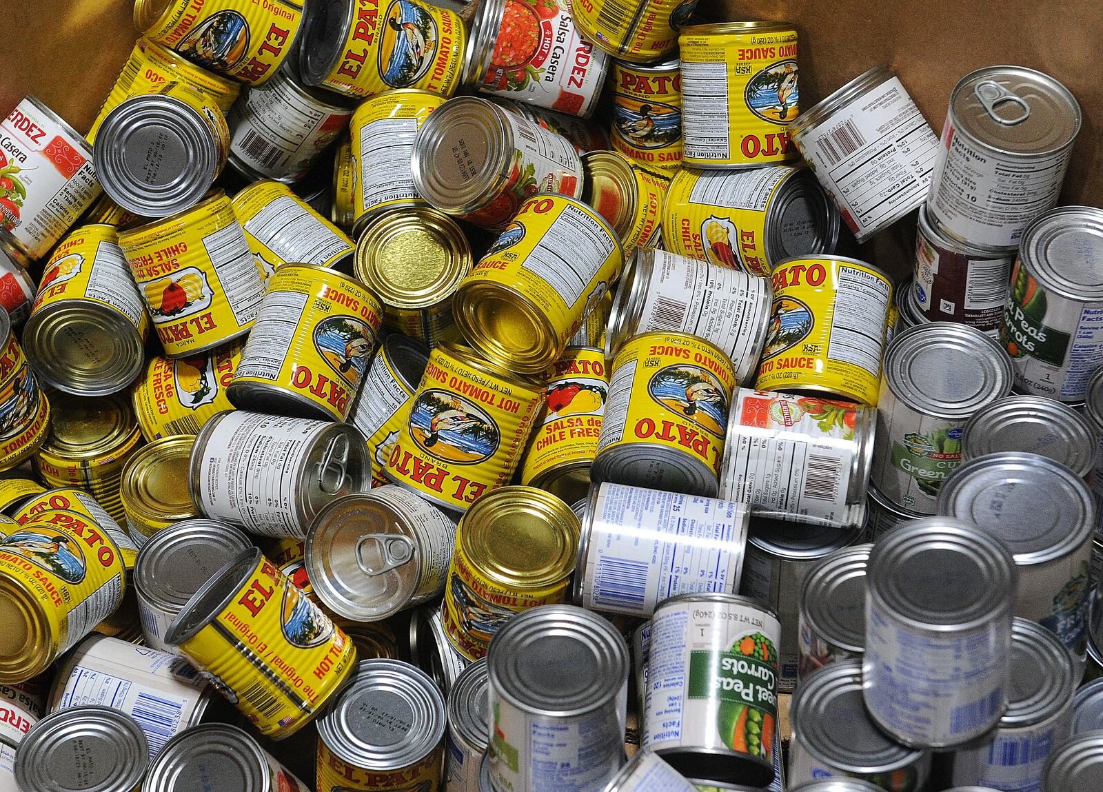 Large bins of canned goods, like peas and tomatoes, take up space in the  Foodbank Inc. warehouse. MARSHALL GORBY\STAFF